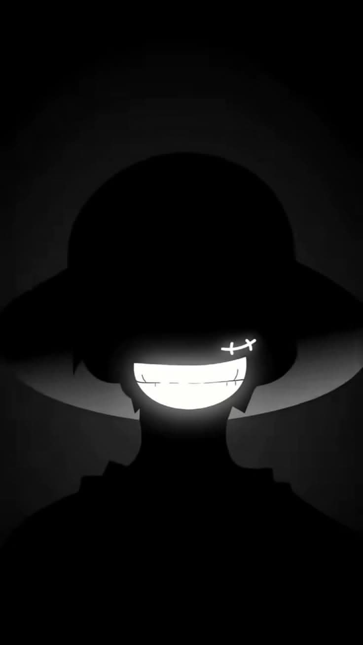 This may contain: the silhouette of a person wearing a hat and glasses with their eyes glowing in the dark