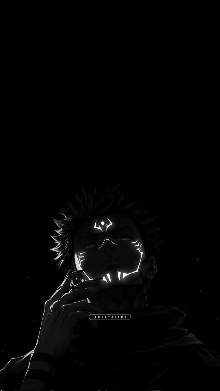 a man holding a cell phone up to his face in front of a black background